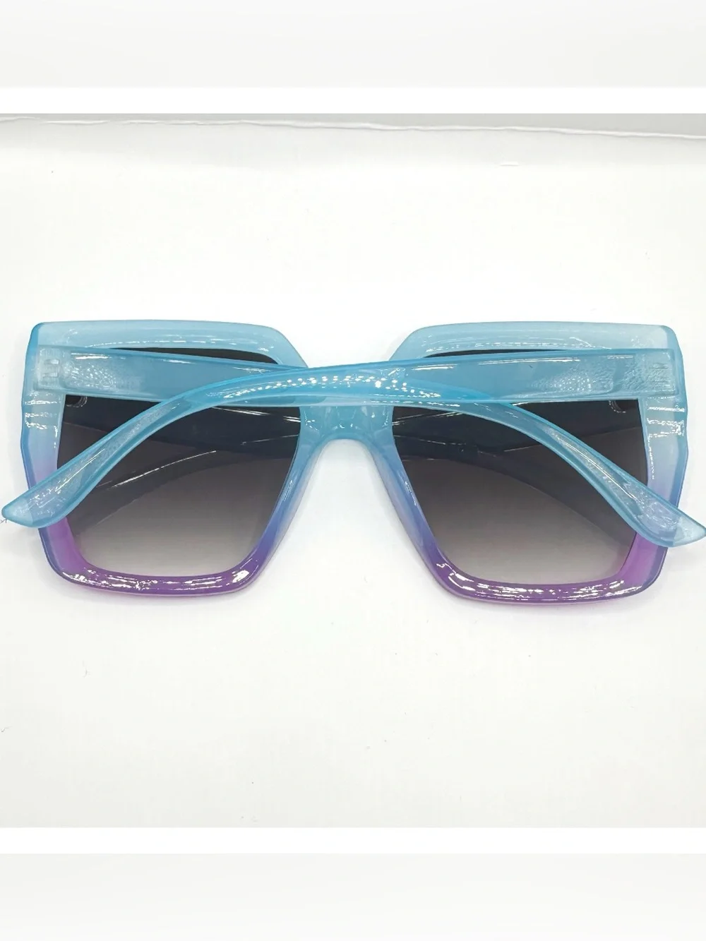 Oversized square women's sunglasses featuring a vibrant light blue-to-purple